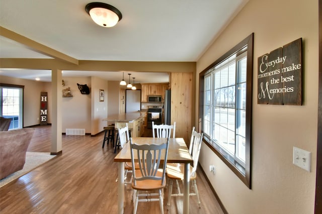40749 Greencrest Rd, Crow River Twp, MN 56312 - dining area with wood finished floors, visible vents, and baseboards