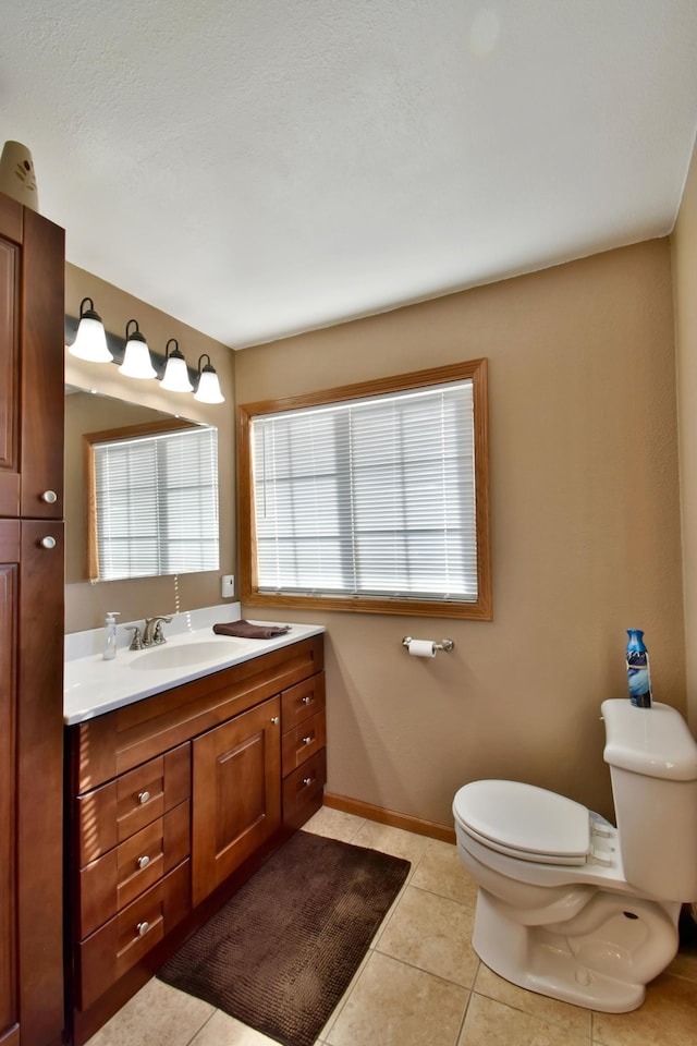 40749 Greencrest Rd, Crow River Twp, MN 56312 - bathroom featuring baseboards, vanity, tile patterned flooring, and toilet