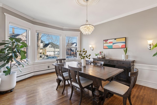 1801 Fremont Ave S Unit 101, Minneapolis, MN 55403 - dining space with a chandelier, a baseboard radiator, crown molding, wood finished floors, and wainscoting