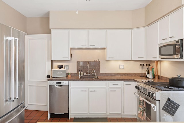 1801 Fremont Ave S Unit 101, Minneapolis, MN 55403 - kitchen featuring high end appliances, a sink, white cabinetry, and tile patterned flooring