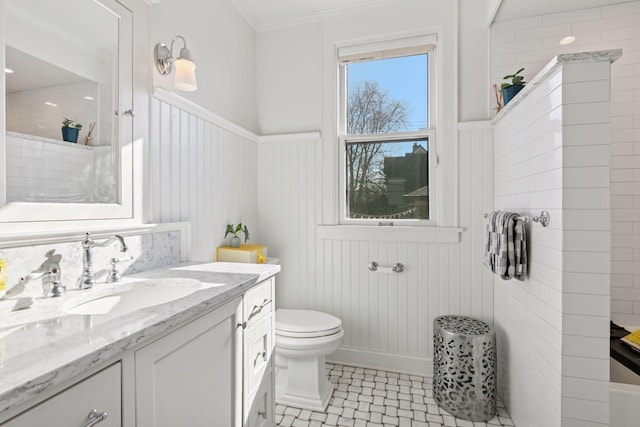 1801 Fremont Ave S Unit 101, Minneapolis, MN 55403 - full bathroom with vanity, wainscoting, toilet, ornamental molding, and a shower
