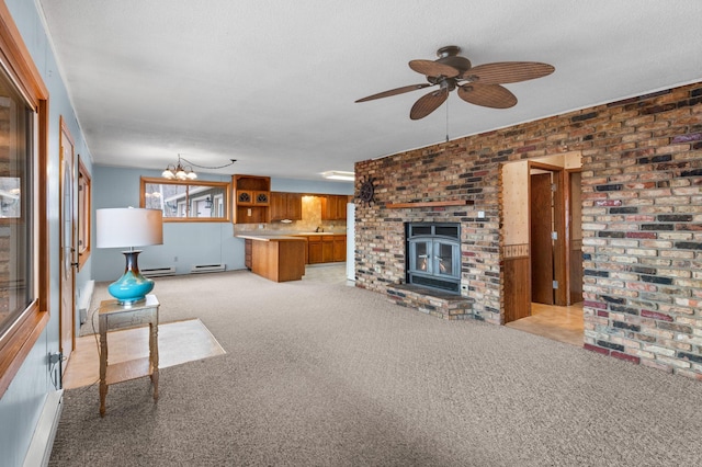 unfurnished living room with ceiling fan with notable chandelier, a textured ceiling, light colored carpet, a baseboard heating unit, and brick wall