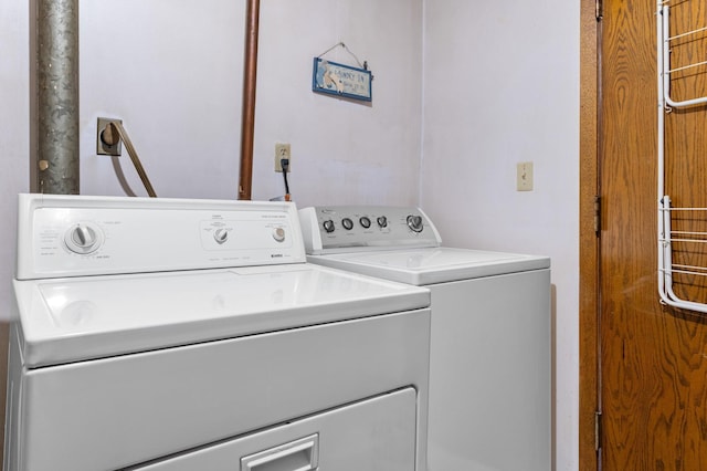washroom with independent washer and dryer and laundry area