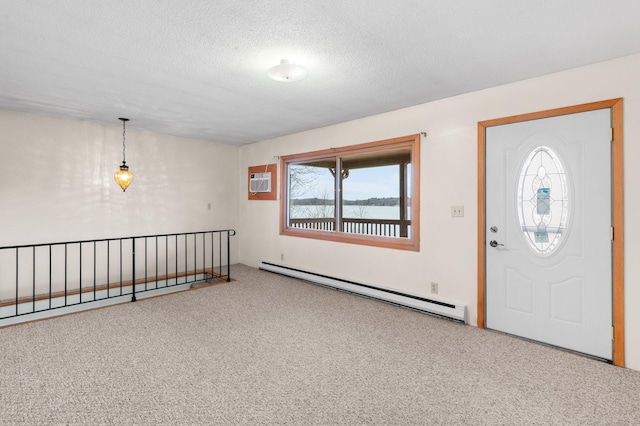 carpeted foyer entrance with a water view, an AC wall unit, a baseboard radiator, and a textured ceiling