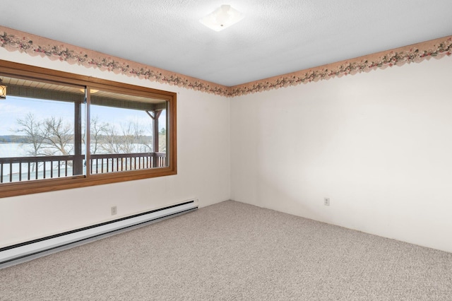 spare room with baseboard heating, carpet, and a water view