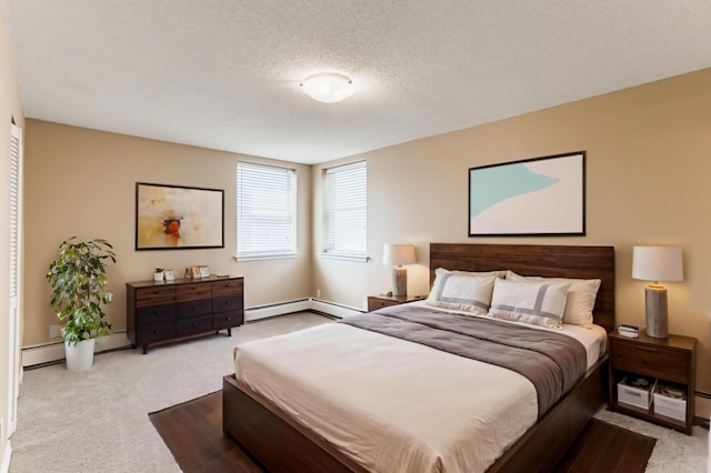 3150 Excelsior Blvd Unit 304, Minneapolis, MN 55416 - bedroom featuring baseboards, carpet, a textured ceiling, and a baseboard radiator