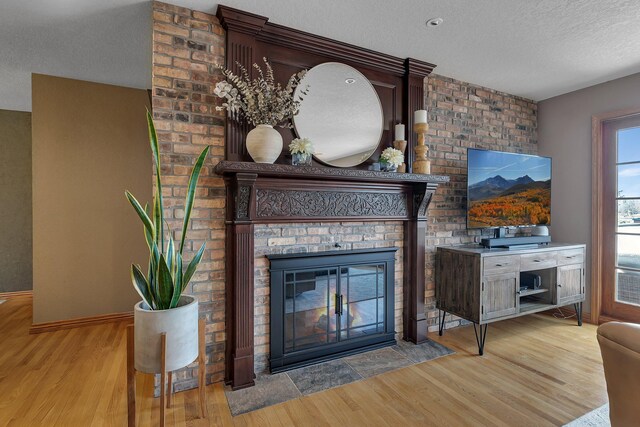 3202 Riviera Rd, Sartell, MN 56377 - living room with baseboards, a textured ceiling, a brick fireplace, and wood finished floors