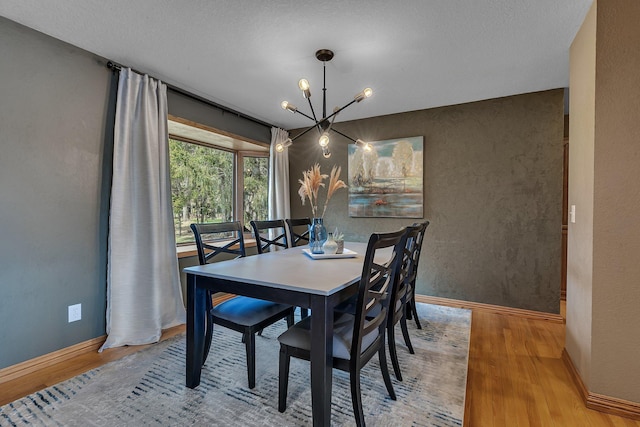 3202 Riviera Rd, Sartell, MN 56377 - dining area featuring an inviting chandelier, baseboards, and wood finished floors