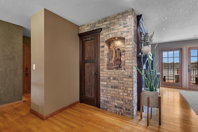 3202 Riviera Rd, Sartell, MN 56377 - entryway featuring baseboards, a textured ceiling, and light wood-style flooring