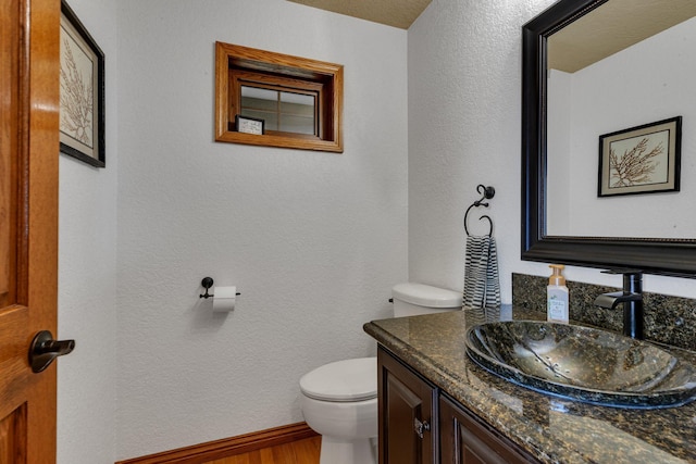3202 Riviera Rd, Sartell, MN 56377 - bathroom with vanity, a textured wall, toilet, and wood finished floors