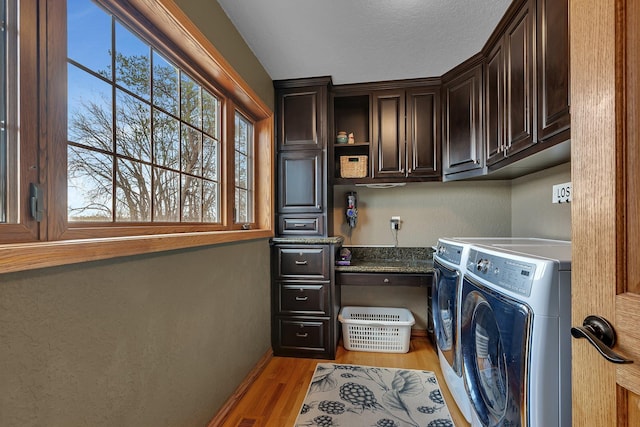 3202 Riviera Rd, Sartell, MN 56377 - laundry room with baseboards, cabinet space, light wood finished floors, and washer and dryer