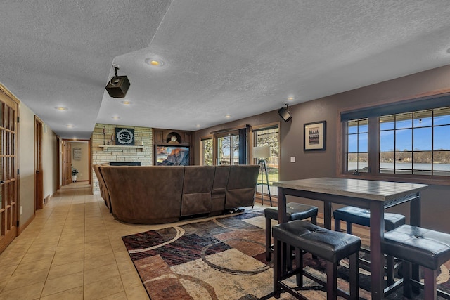 3202 Riviera Rd, Sartell, MN 56377 - living room with recessed lighting, a textured ceiling, light tile patterned floors, and a fireplace