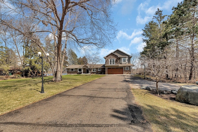 3202 Riviera Rd, Sartell, MN 56377 - view of front of property with an attached garage, driveway, a front lawn, and stone siding