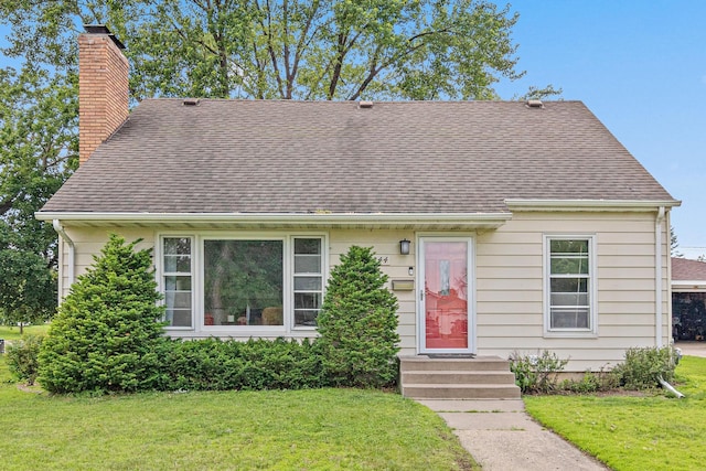 7244 12th Ave S, Richfield, MN 55423 - view of front of house with a chimney, a front lawn, and roof with shingles