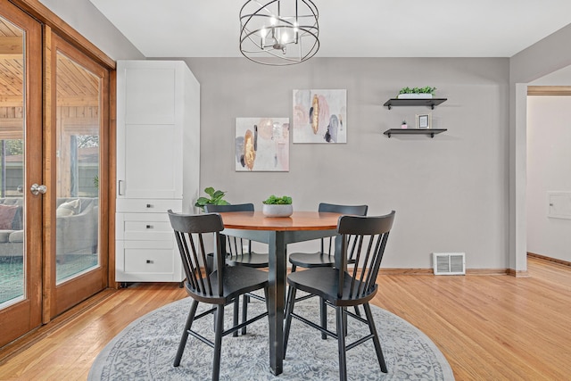7244 12th Ave S, Richfield, MN 55423 - dining room featuring light wood-style flooring, a chandelier, and french doors