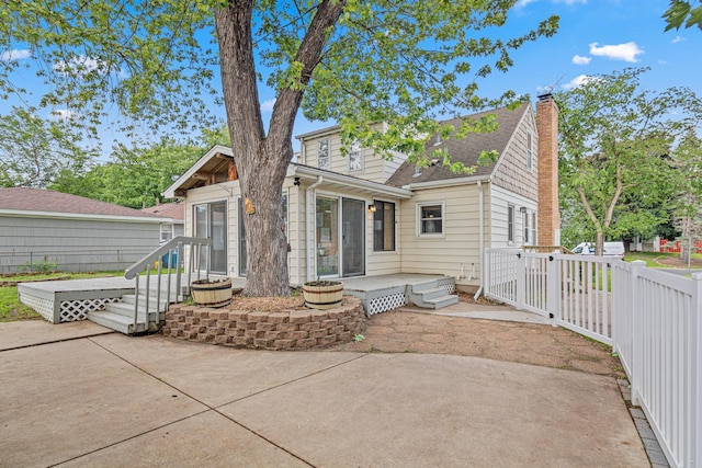 7244 12th Ave S, Richfield, MN 55423 - back of house with a patio, a chimney, and roof with shingles