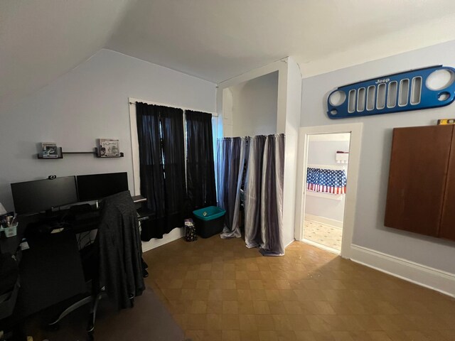 office area featuring lofted ceiling and tile patterned floors