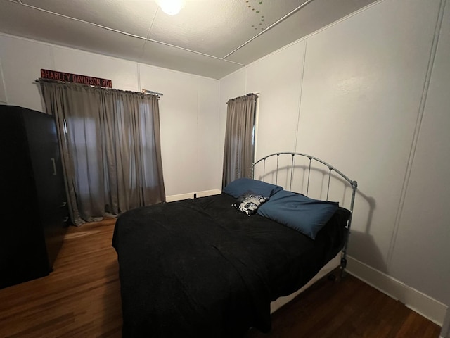 bedroom featuring wood finished floors and baseboards