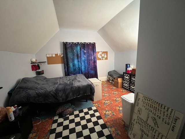 carpeted bedroom with vaulted ceiling