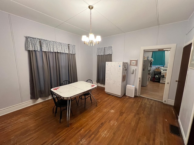 dining area featuring a chandelier and hardwood / wood-style floors