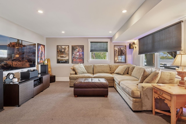 living area featuring light colored carpet, a wealth of natural light, baseboards, and recessed lighting