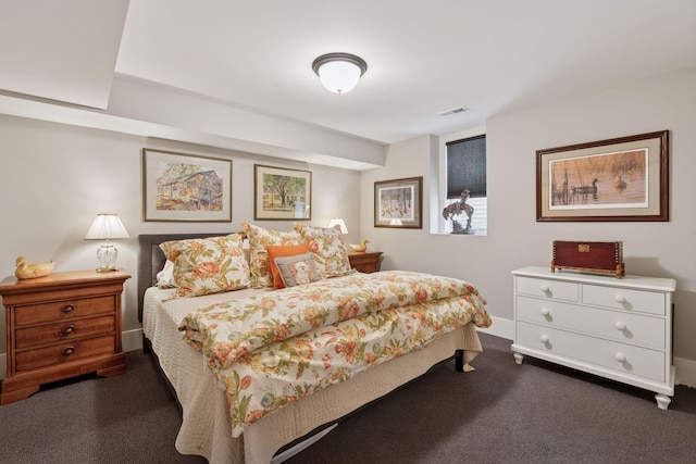 bedroom with dark colored carpet, baseboards, and visible vents