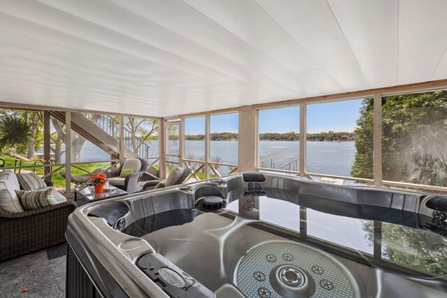 sunroom / solarium with a water view