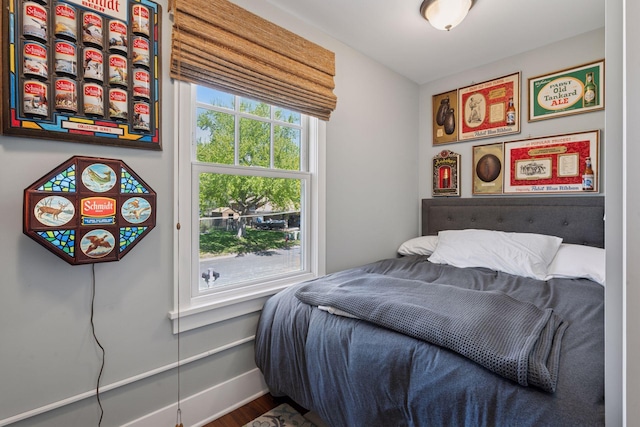 bedroom featuring baseboards and wood finished floors