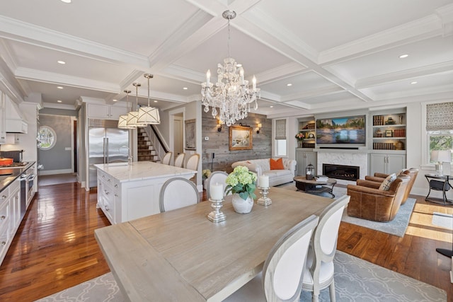 dining area featuring stairway, a high end fireplace, coffered ceiling, and dark wood finished floors