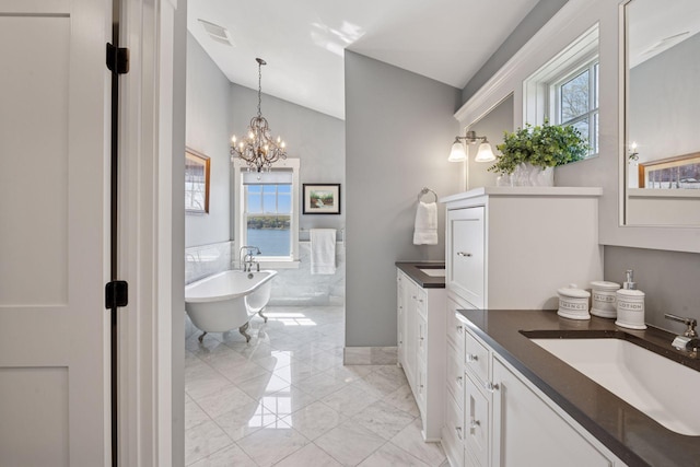 full bathroom with a sink, two vanities, visible vents, vaulted ceiling, and marble finish floor