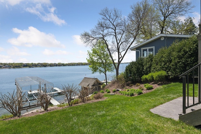 view of yard featuring a water view and a dock