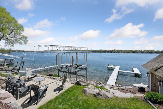 dock area featuring boat lift and a water view