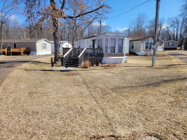 view of front of home featuring a deck and a residential view