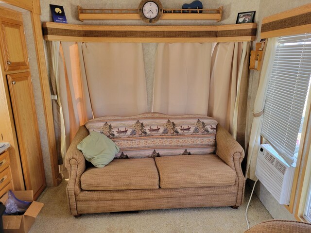living area featuring cooling unit and light colored carpet