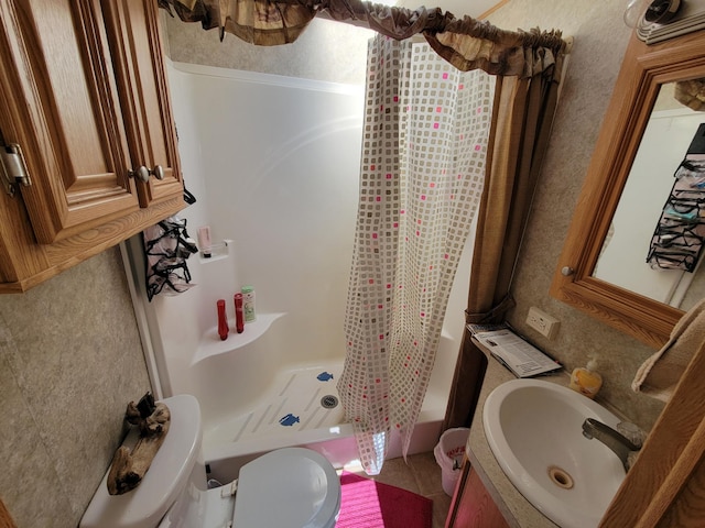 bathroom featuring shower / bath combination with curtain, toilet, and vanity