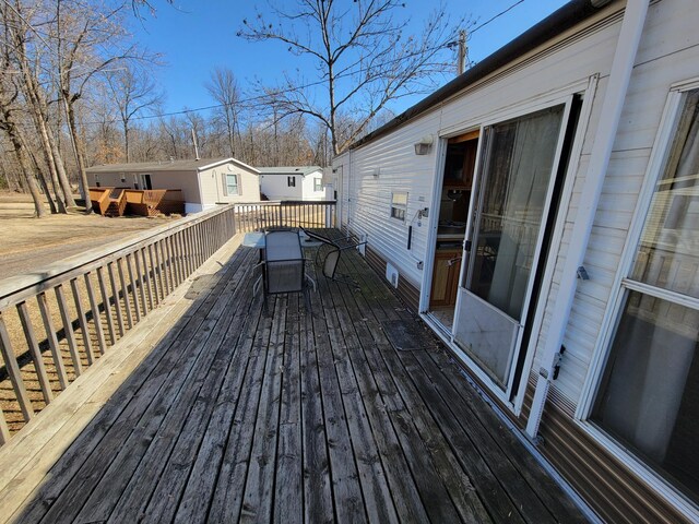 wooden terrace featuring outdoor dining area