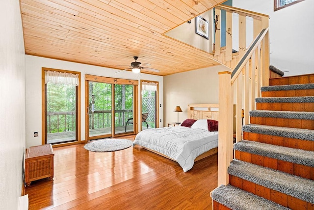 bedroom with wood ceiling, access to exterior, and wood finished floors