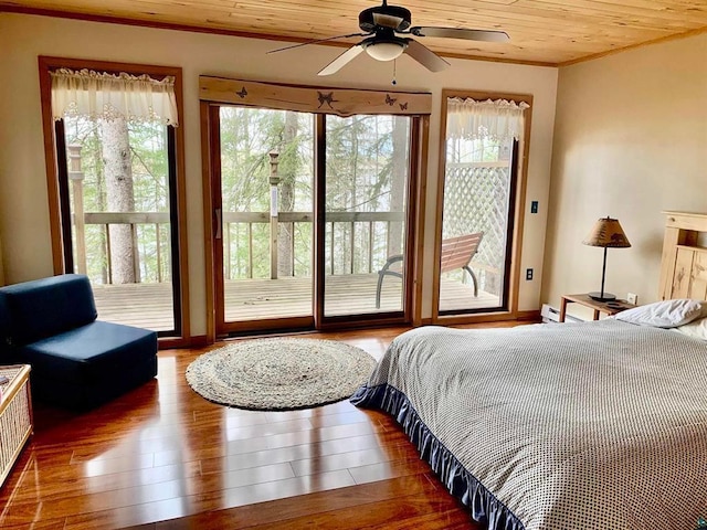 bedroom with access to exterior, wood finished floors, wood ceiling, and ornamental molding