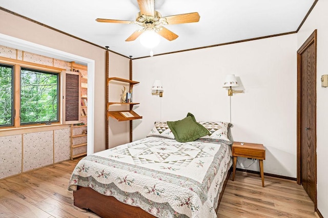 bedroom featuring ceiling fan, wood finished floors, and crown molding