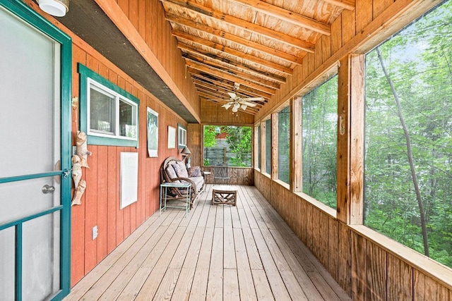 unfurnished sunroom with a ceiling fan
