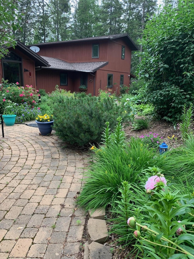 exterior space with a shingled roof