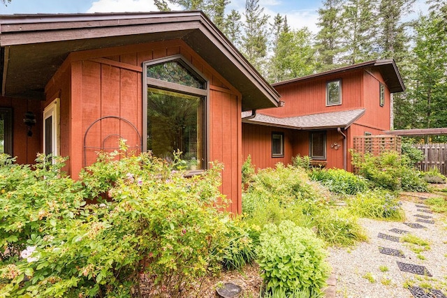 view of side of home featuring fence