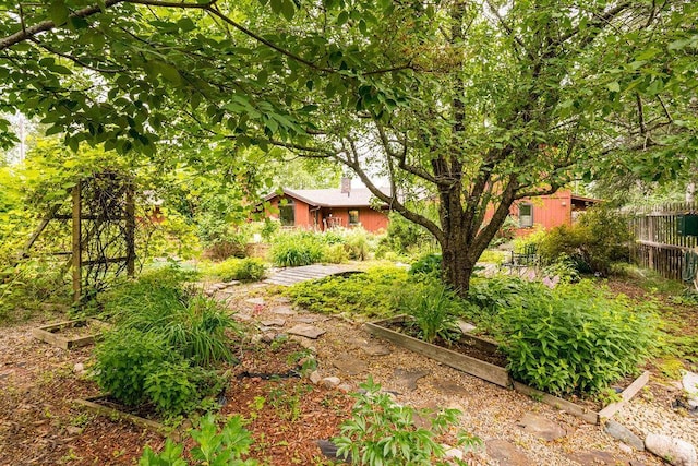 view of yard with fence and a garden