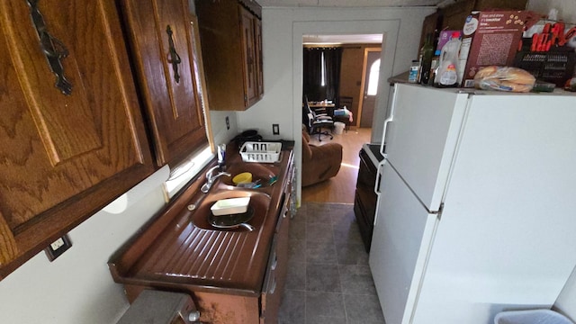 810 11th Ave SW, Austin, MN 55912 - kitchen featuring dark tile patterned flooring and freestanding refrigerator