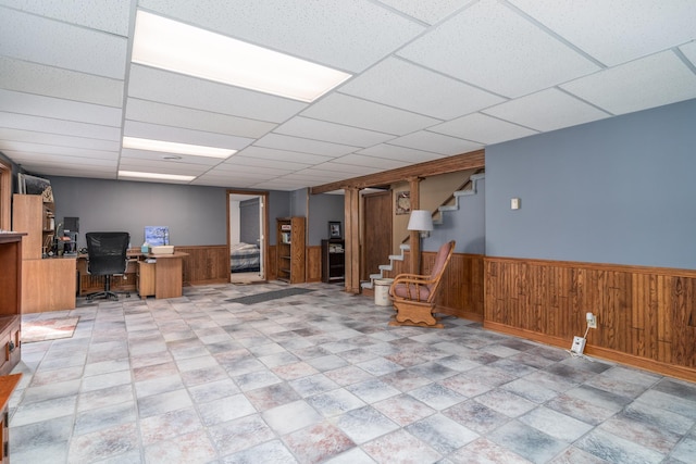 27192 237th Ave SW, Crookston Twp, MN 56716 - finished below grade area with stairway, wainscoting, an office area, wood walls, and a drop ceiling