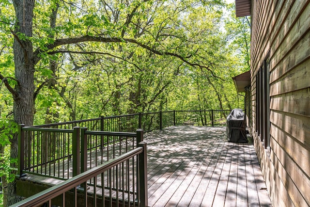 27192 237th Ave SW, Crookston Twp, MN 56716 - wooden terrace featuring grilling area and a wooded view