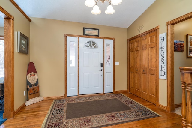 27192 237th Ave SW, Crookston Twp, MN 56716 - entrance foyer featuring wood finished floors, a chandelier, and baseboards