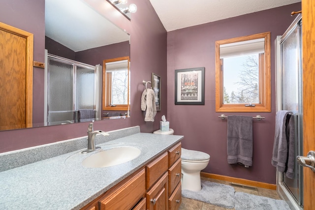27192 237th Ave SW, Crookston Twp, MN 56716 - full bathroom featuring vanity, a shower stall, toilet, tile patterned flooring, and baseboards
