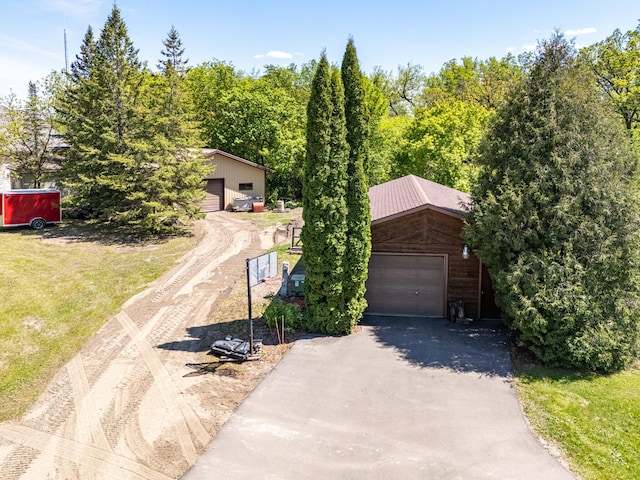 27192 237th Ave SW, Crookston Twp, MN 56716 - obstructed view of property with a detached garage, asphalt driveway, and an outdoor structure