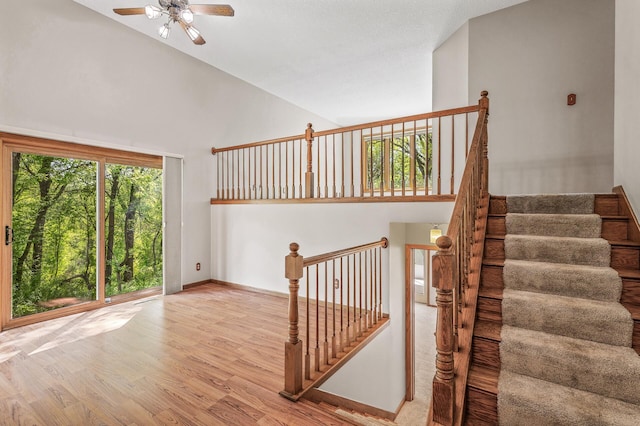 13838 Glendale Trl, Savage, MN 55378 - stairway with high vaulted ceiling, wood finished floors, ceiling fan, and baseboards